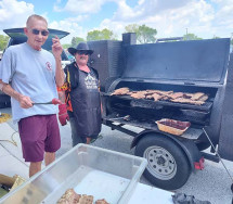 men cooking ribs outside